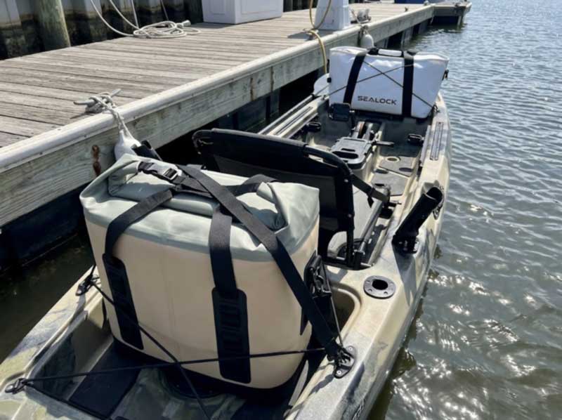 soft cooler strapped into a kayak tank well with a fish bag on the bow soft cooler strapped into a kayak tank well with a fish bag on the bow